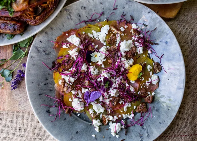 Golden beet carpaccio with feta, candied pecans and flowers