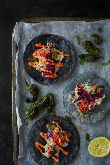 Crab tacos on a baking tray with lime