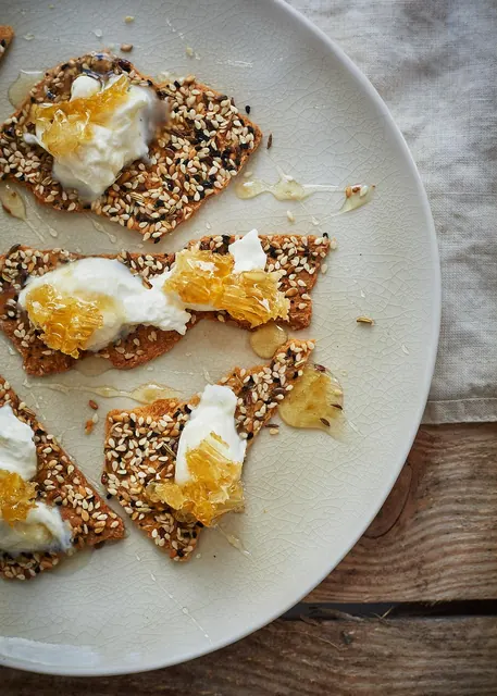 Seeded crackers with whipped ricotta and honeycomb